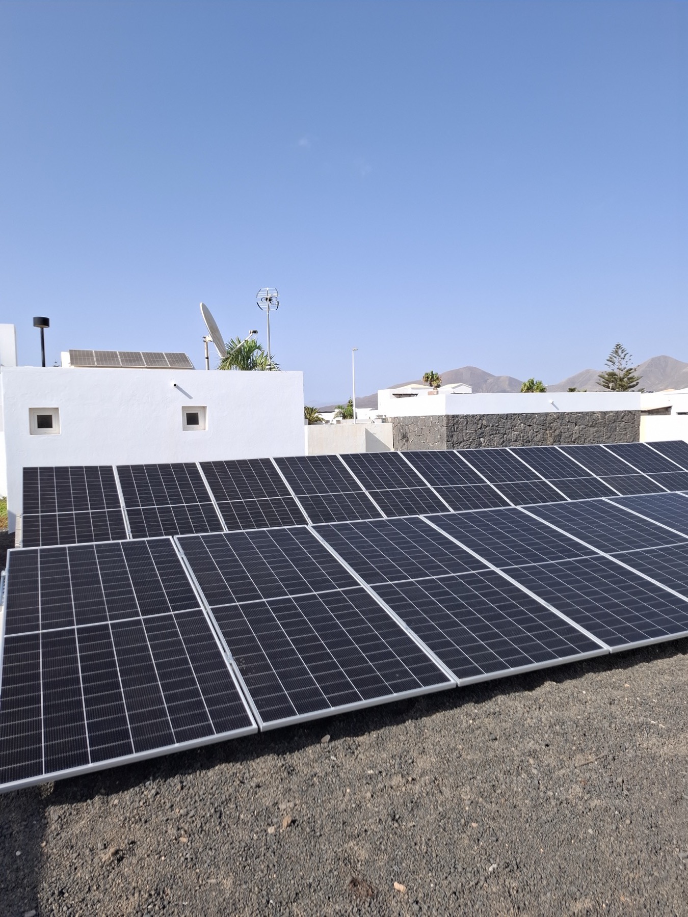 Solar panel array on a villa rooftop